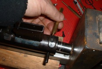 Pushing out the spring guide retaining dowel