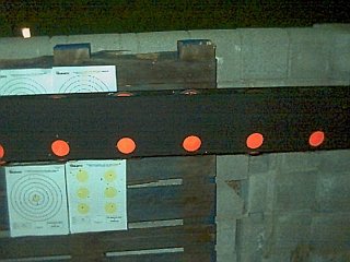 Close-up of clay pigeon gallery slots and wire supports