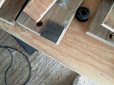 Two holes drilled in opposite corners of the paddle