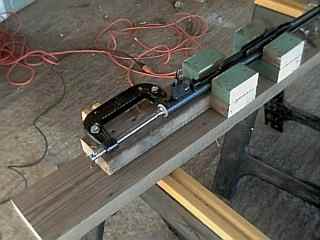 C-clamp raised on washers to center on the spring guide